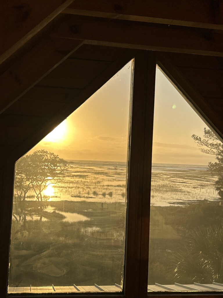 a view of a sunset through a window (MyCoast AI)