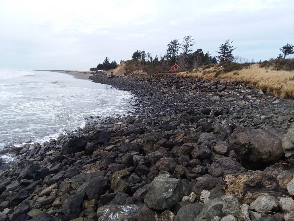 a rocky beach with a red house (MyCoast AI)