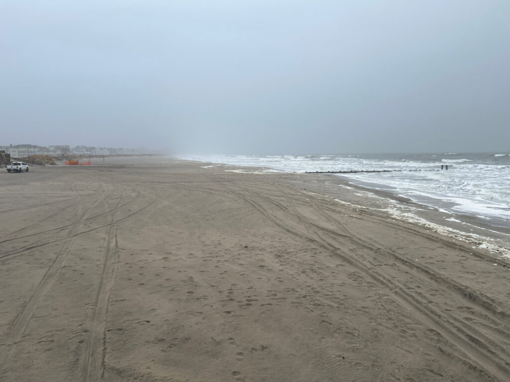 a sandy beach with waves crashing on it (MyCoast AI)