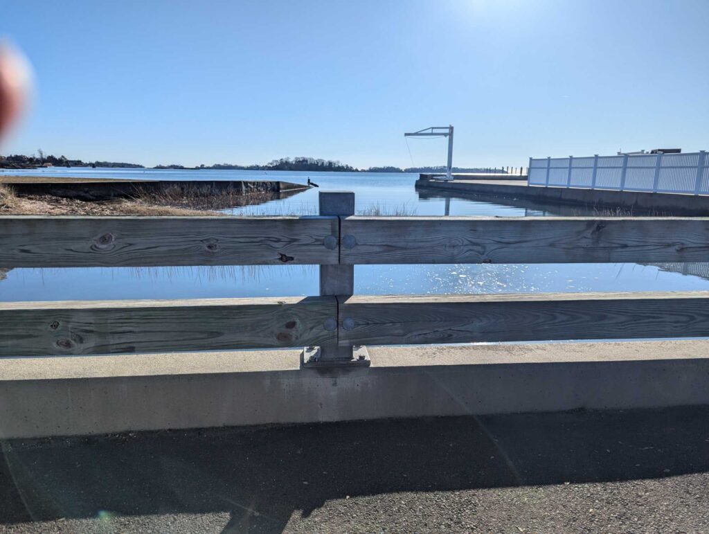 a wooden bench overlooking a body of water (MyCoast AI)