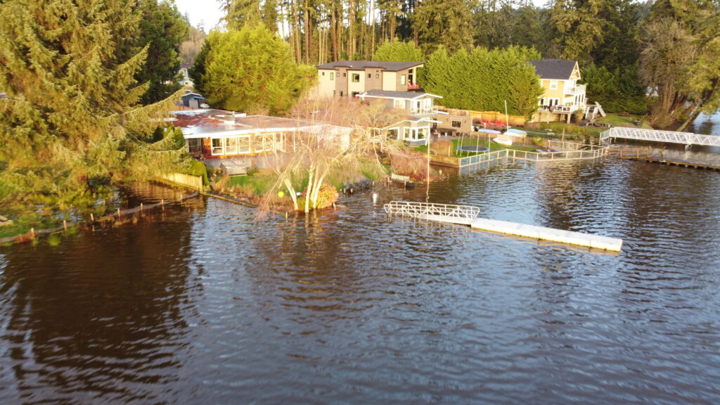 a body of water with a dock and buildings along it (MyCoast AI)