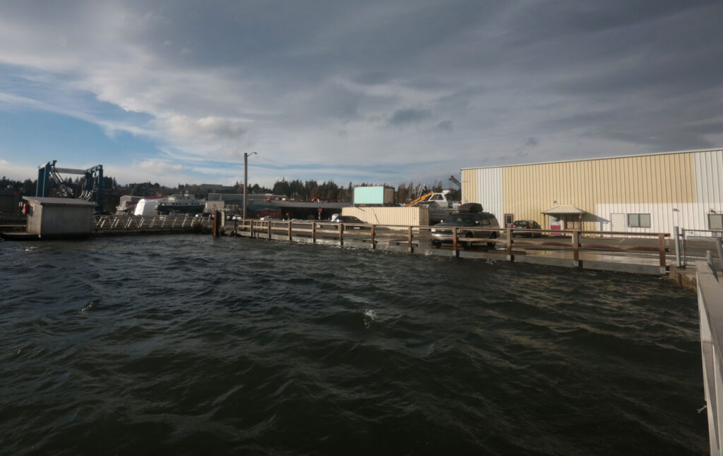 a body of water with a dock and buildings along it (MyCoast AI)