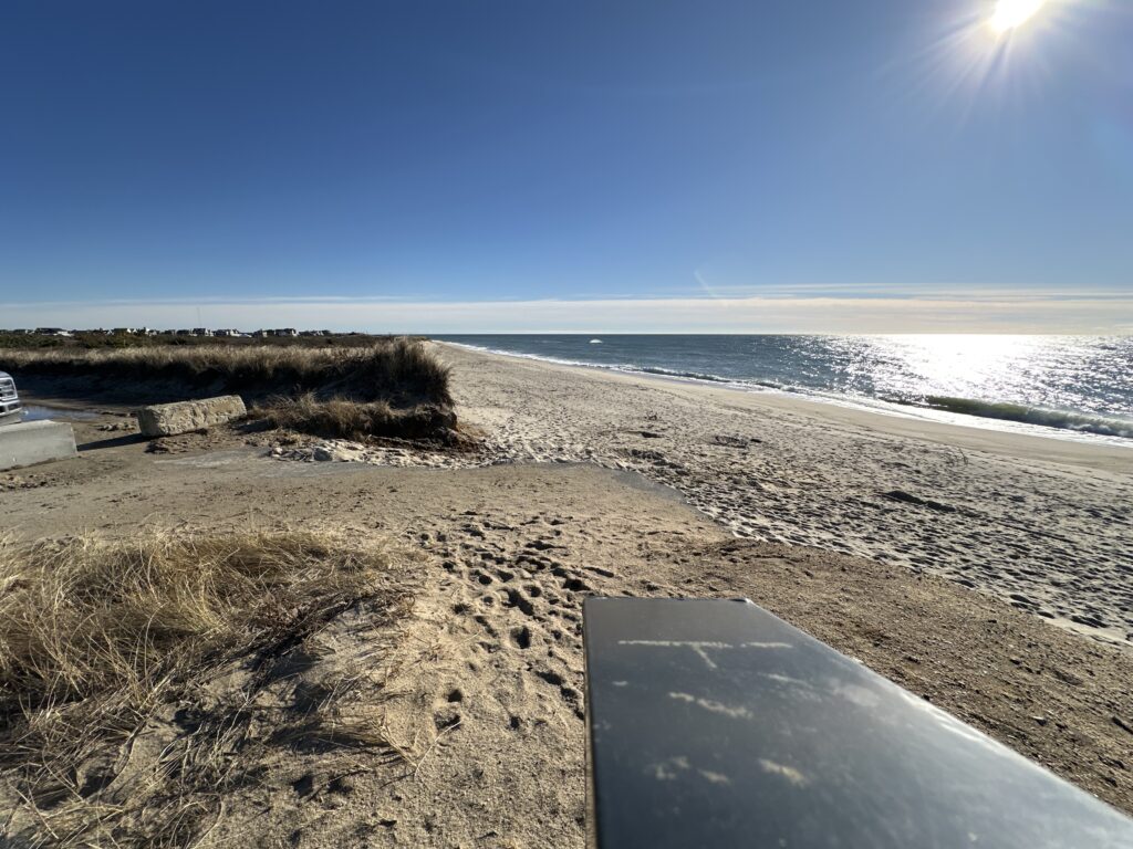 a sandy beach with a surfboard (MyCoast AI)