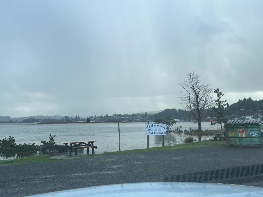 a body of water with a dock and a sign on it (MyCoast AI)