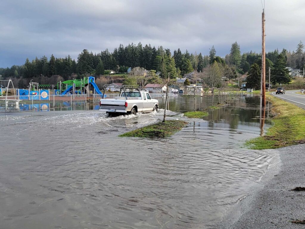 a truck driving through a flooded area (MyCoast AI)