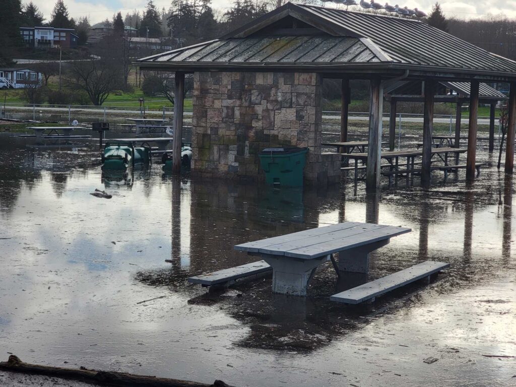 a flooded area with a bench and a building (MyCoast AI)