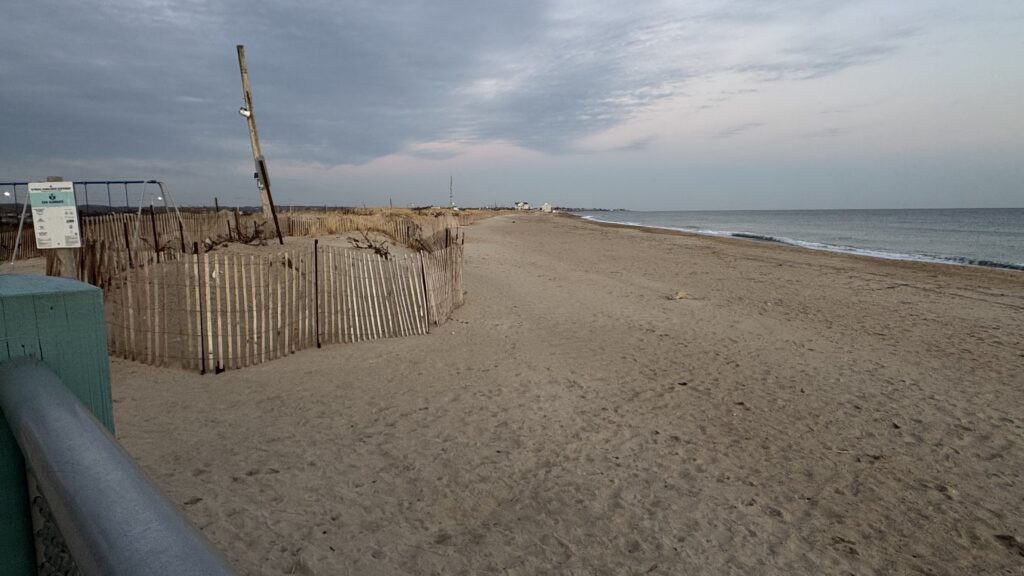 a sandy beach with a fence (MyCoast AI)