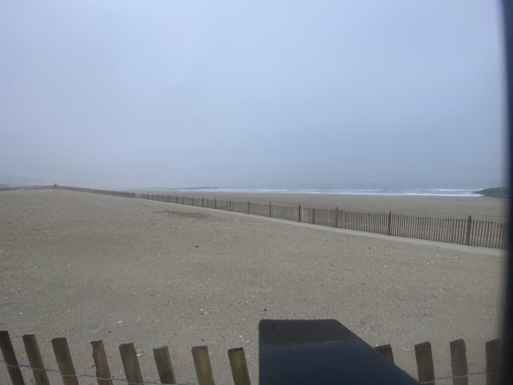a sandy beach with a fence (MyCoast AI)