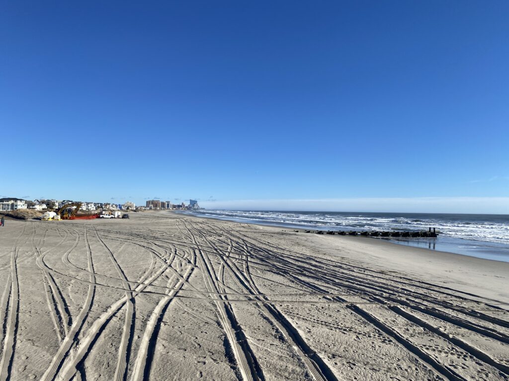 a beach with tracks in the sand (MyCoast AI)