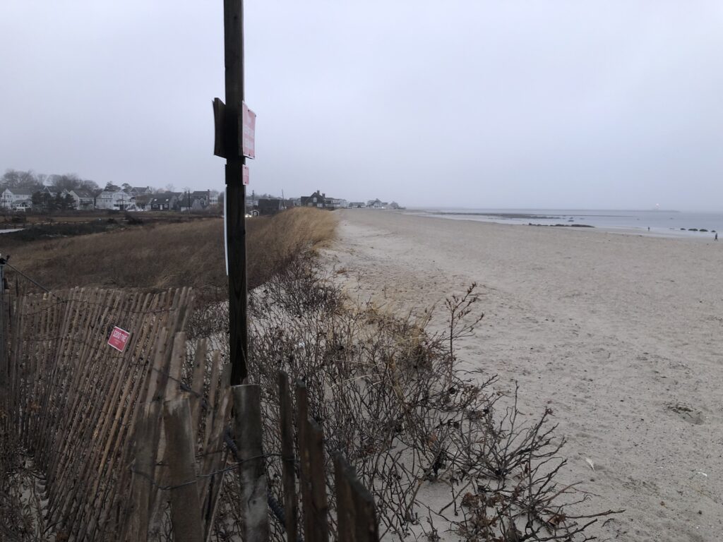 a beach with a fence and a sign (MyCoast AI)