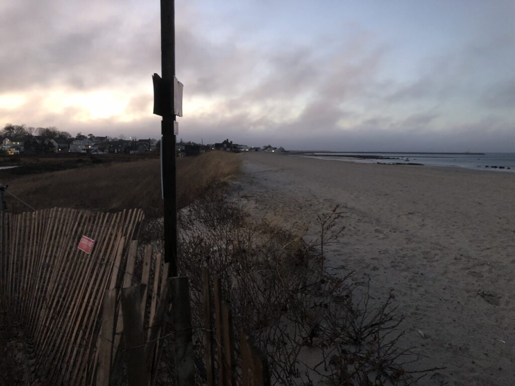 a beach with a fence and a sign (MyCoast AI)