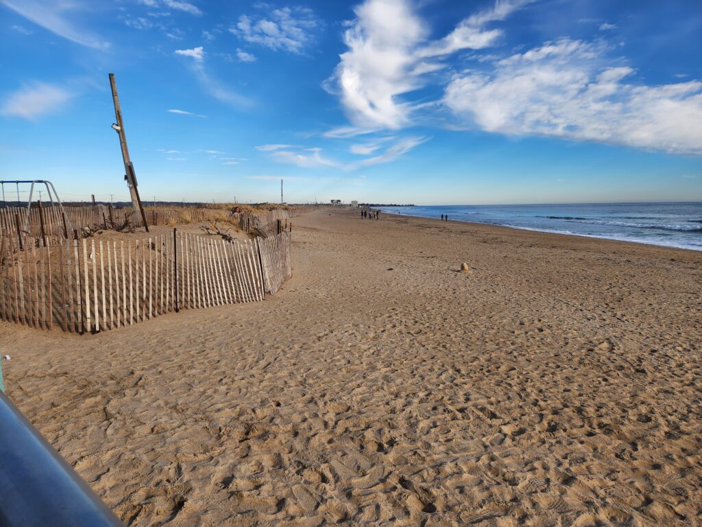 a sandy beach with a fence (MyCoast AI)
