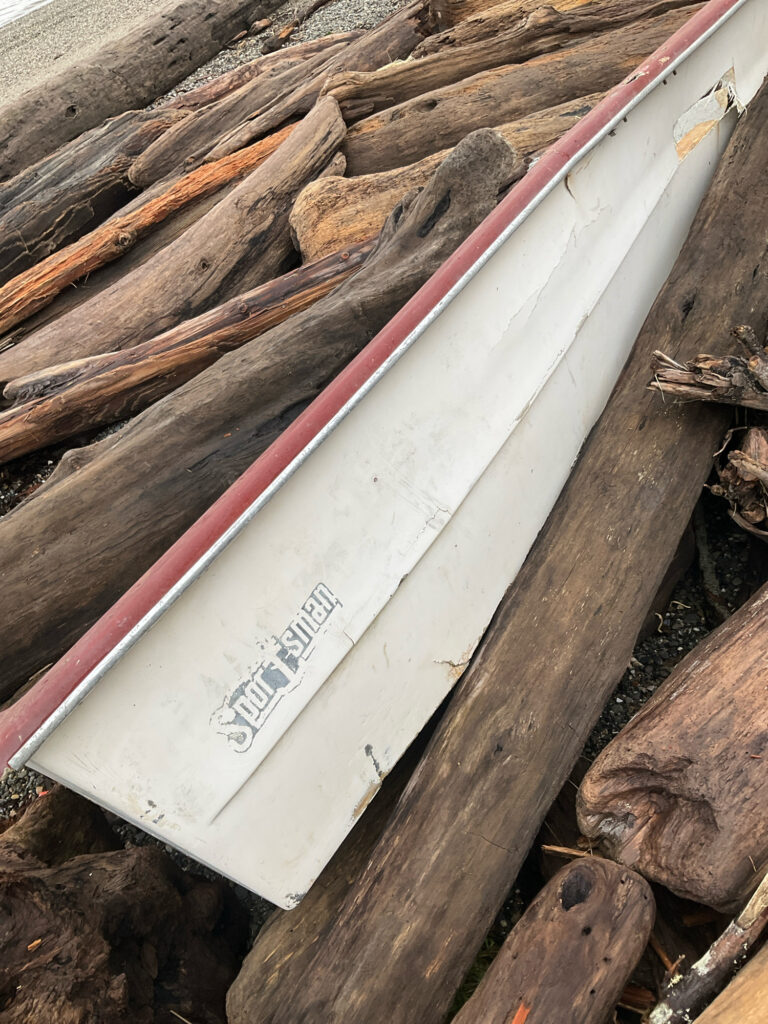 a white and pink surfboard on a wooden surface (MyCoast AI)
