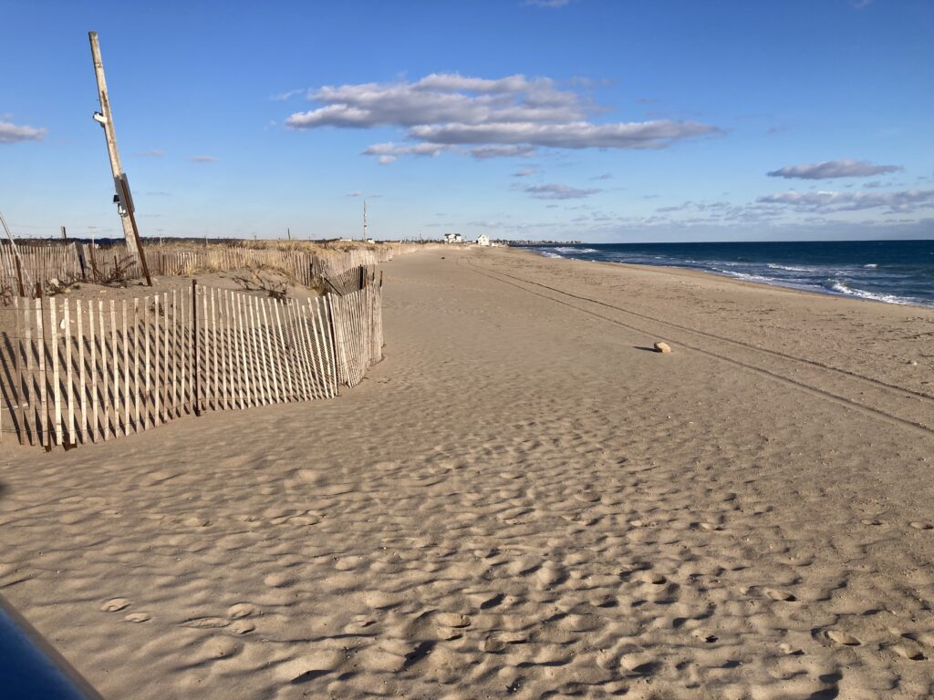 a sandy beach with a fence (MyCoast AI)