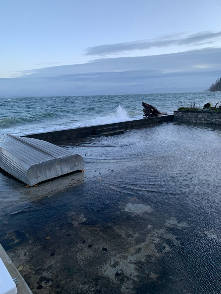 a body of water with a dock and a concrete wall (MyCoast AI)