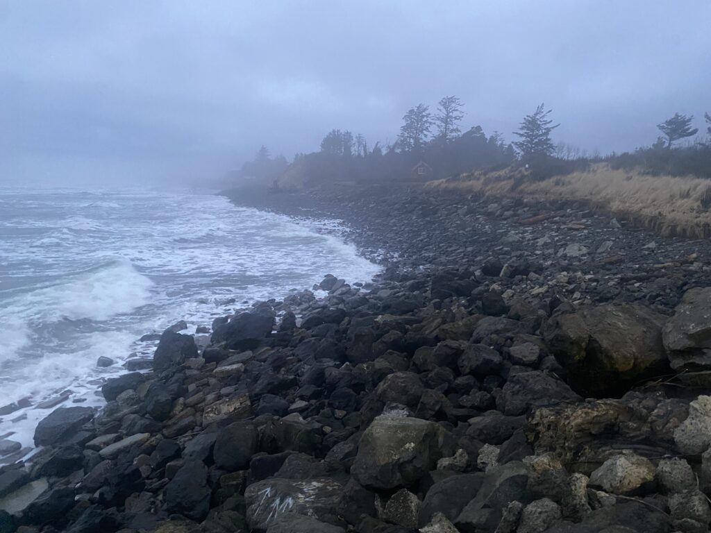 a rocky beach with waves crashing on it (MyCoast AI)
