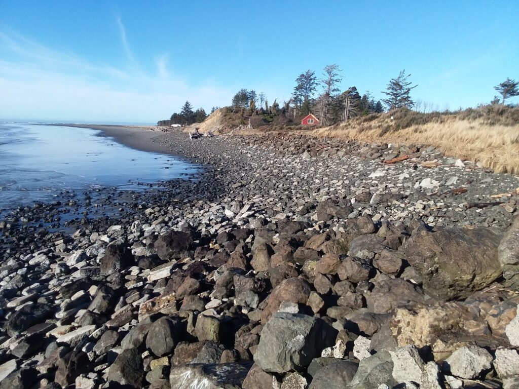 a rocky beach with a red house (MyCoast AI)