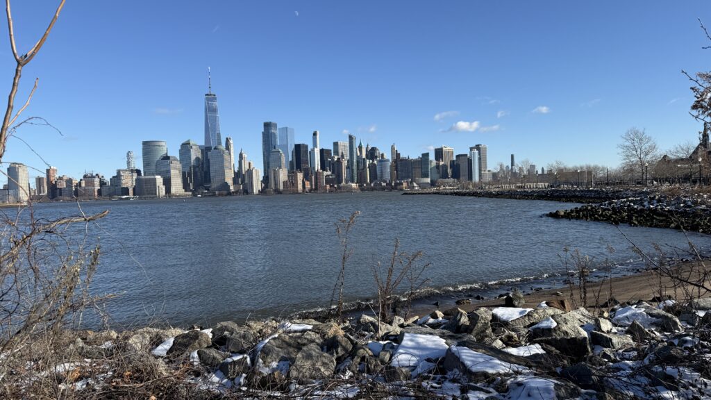 a city skyline across a body of water (MyCoast AI)