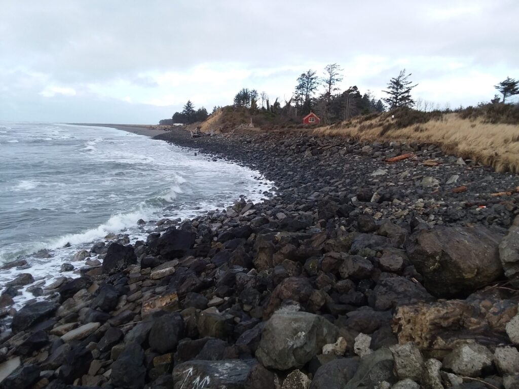 a rocky beach with a red tent (MyCoast AI)