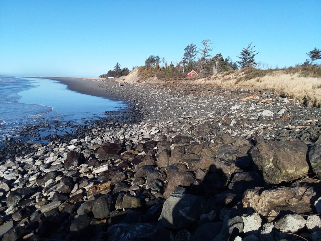 a rocky beach with a red tent (MyCoast AI)