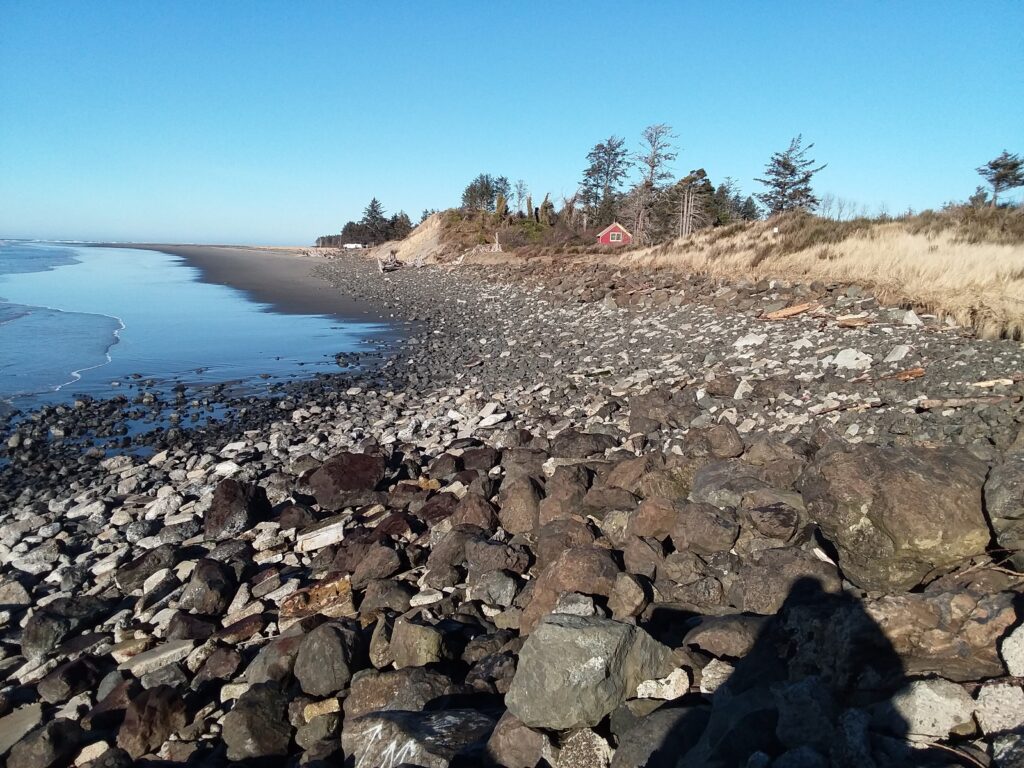 a rocky beach with a body of water in the background (MyCoast AI)