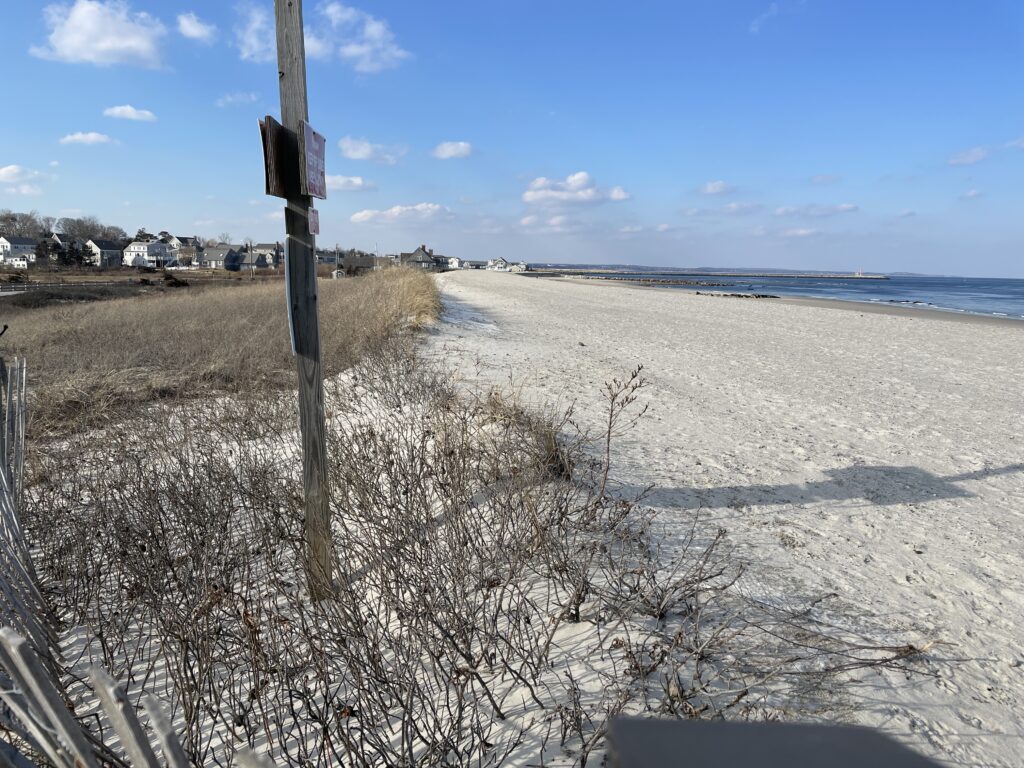 a beach with a fence and a pole (MyCoast AI)
