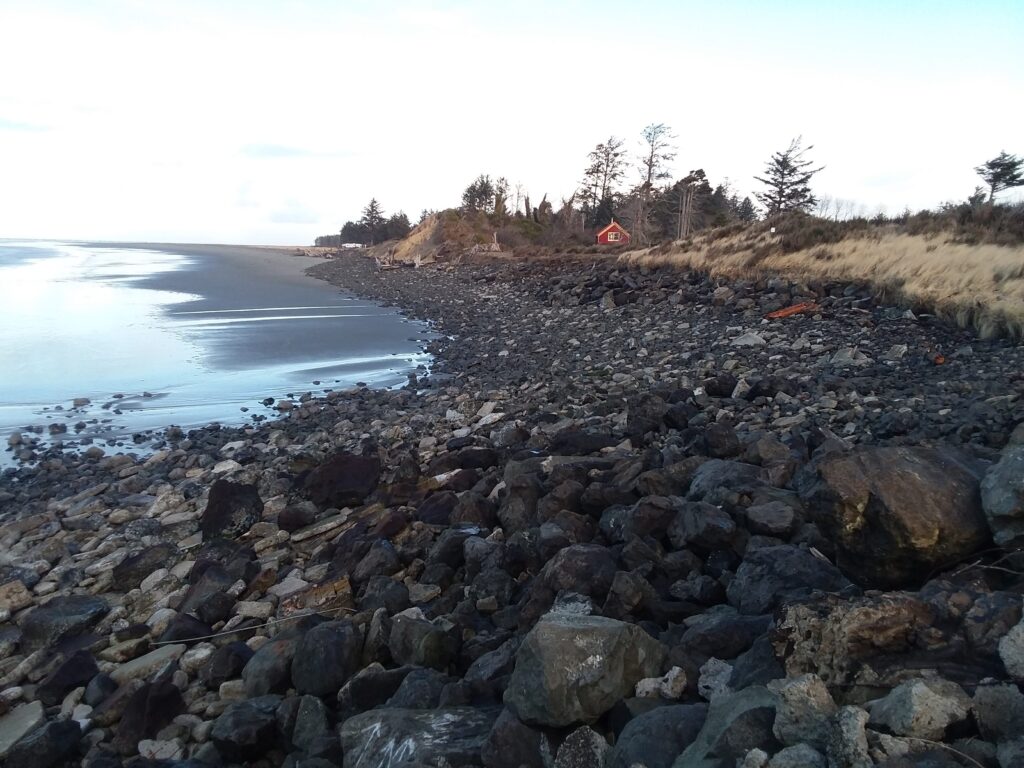 a rocky beach with a red tent (MyCoast AI)