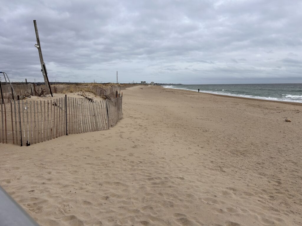 a sandy beach with a fence (MyCoast AI)