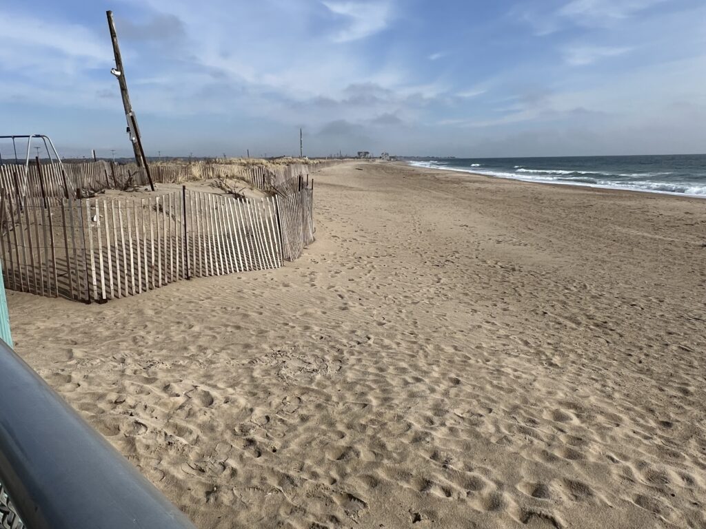 a sandy beach with a fence (MyCoast AI)
