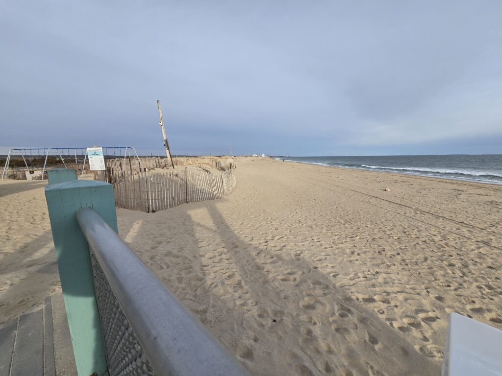 a sandy beach with a fence (MyCoast AI)