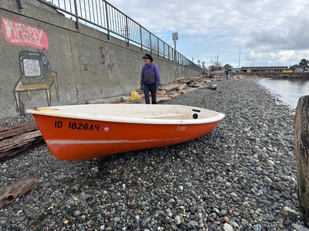a person standing next to a boat (MyCoast AI)