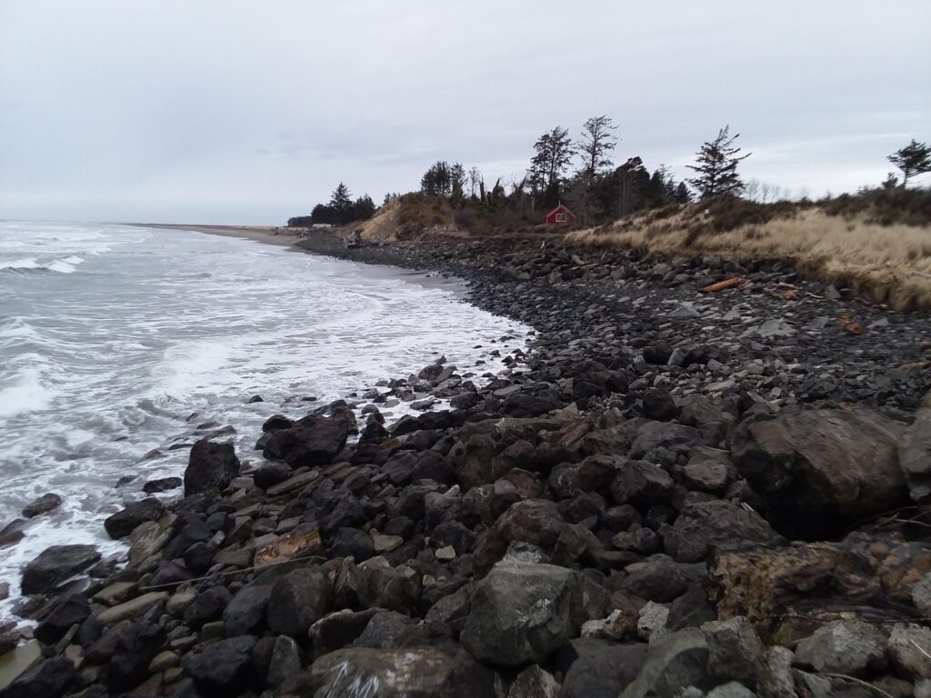 a rocky beach with a red tent (MyCoast AI)