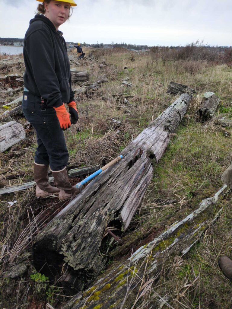 a man standing next to a log (MyCoast AI)