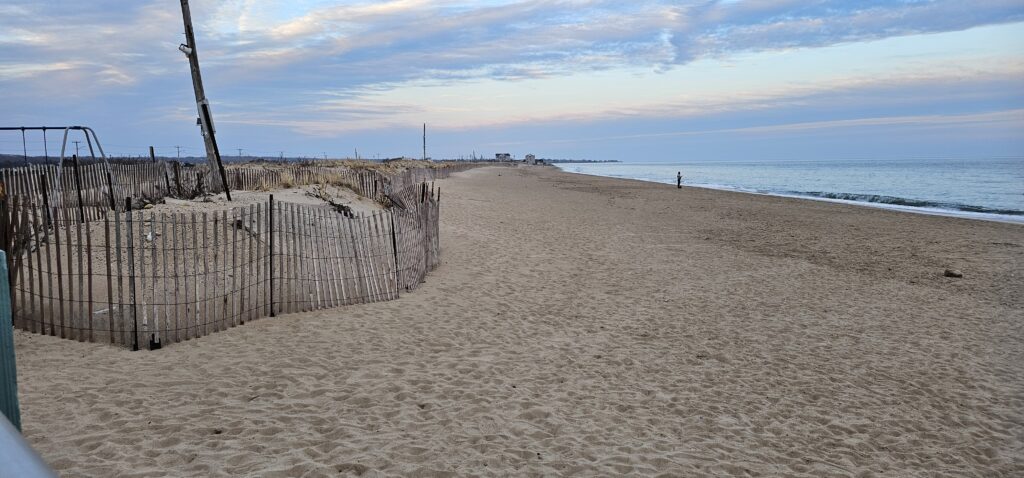 a sandy beach with a fence (MyCoast AI)