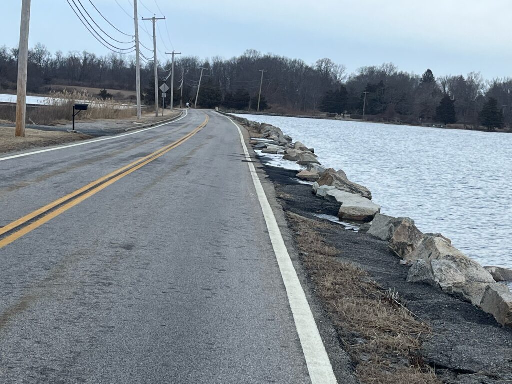 a road next to a body of water (MyCoast AI)