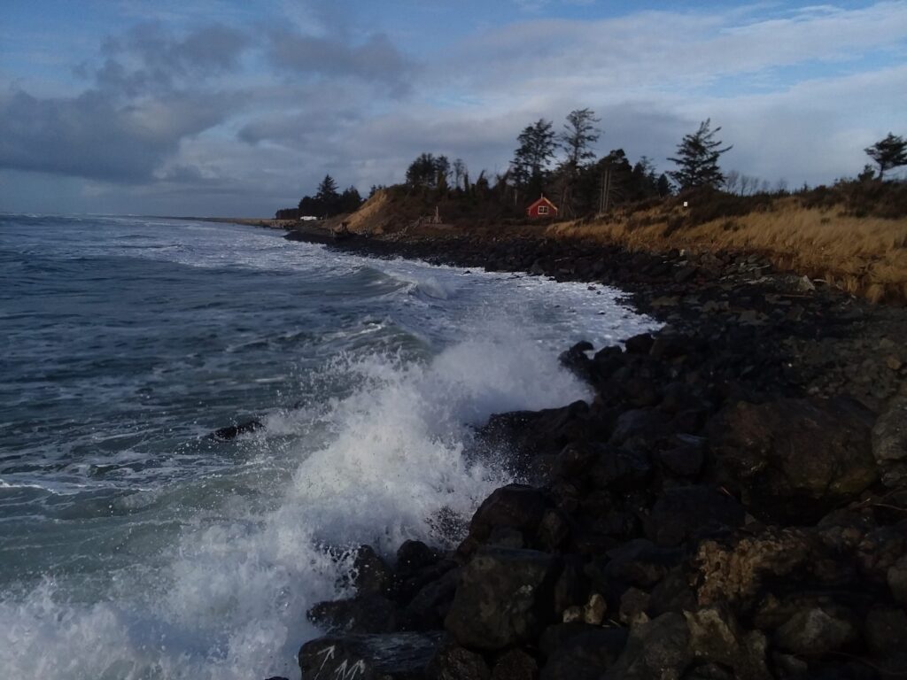 a rocky beach with waves crashing on it (MyCoast AI)