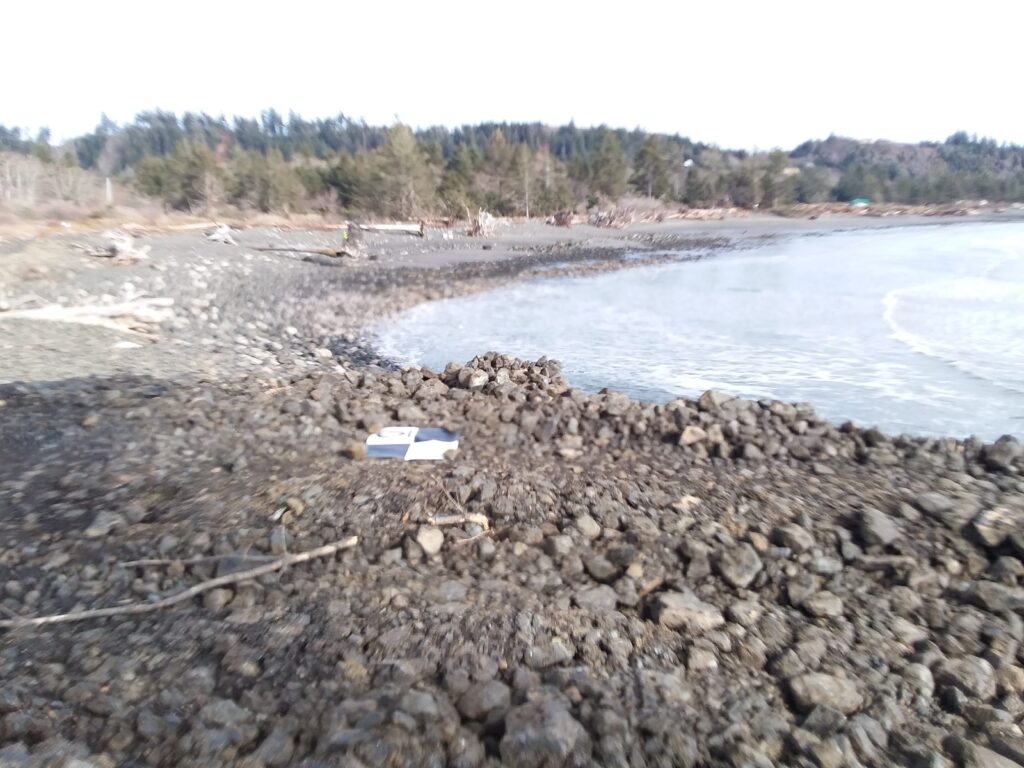 a rocky beach with a bench (MyCoast AI)