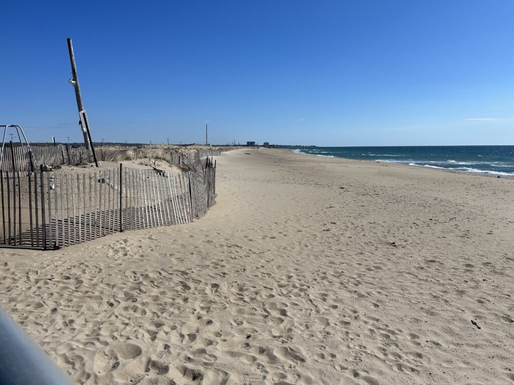 a sandy beach with a fence (MyCoast AI)