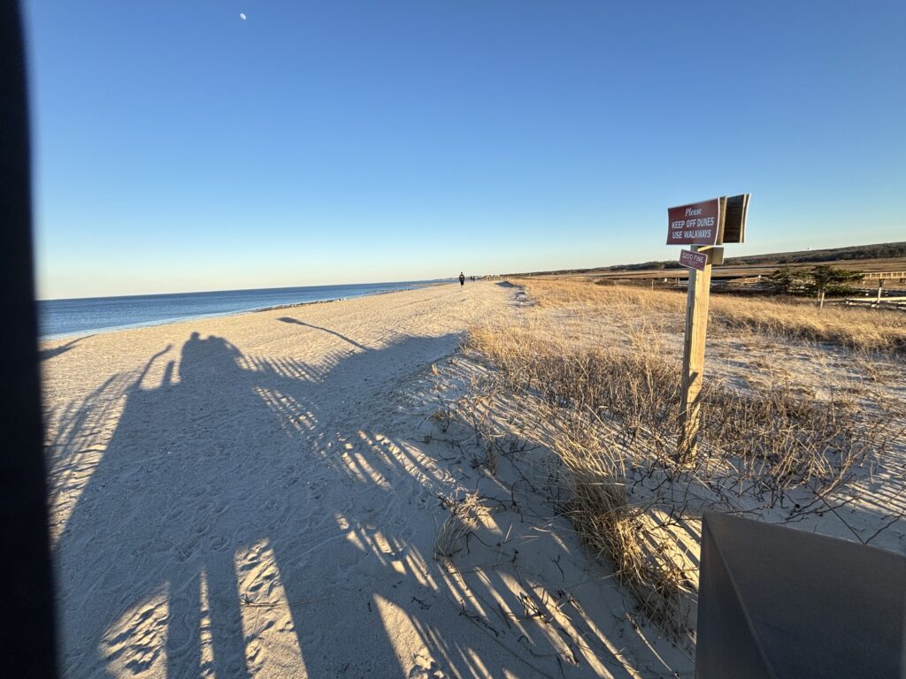 a sandy beach with a sign (MyCoast AI)