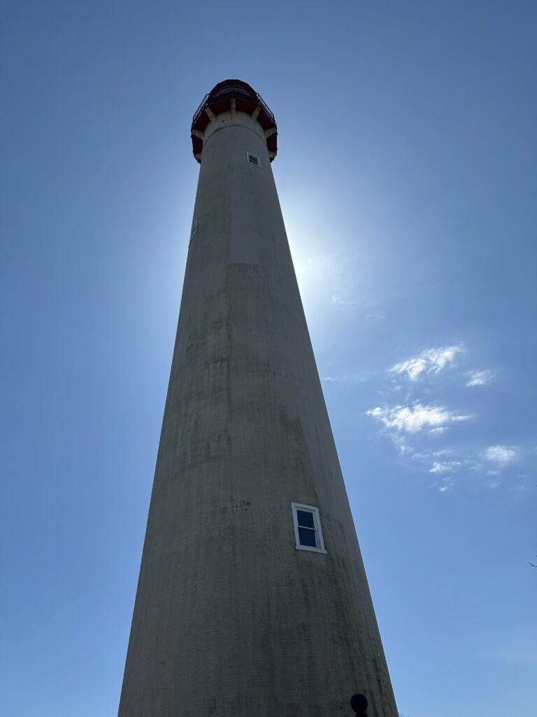 a tall tower with a red and white top (MyCoast AI)