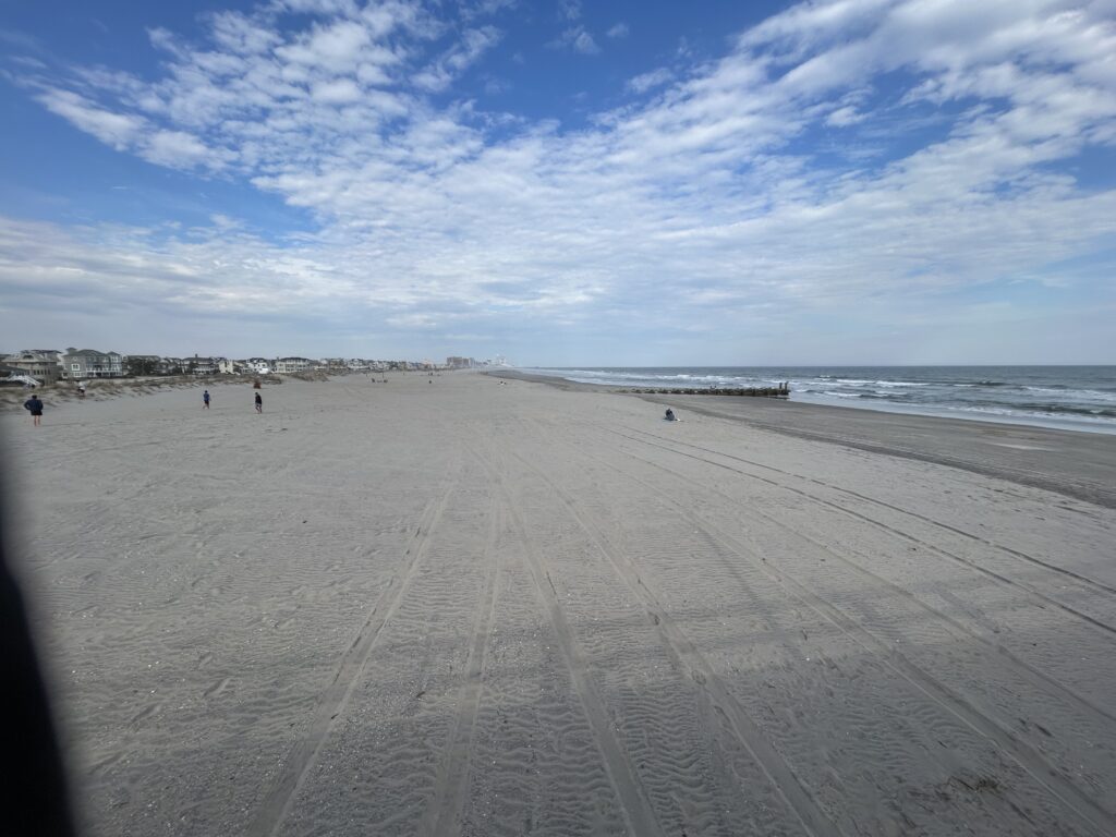 a sandy beach with people walking on it (MyCoast AI)