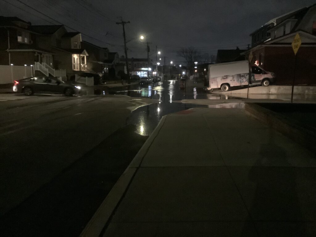 a street with cars and buildings at night (MyCoast AI)