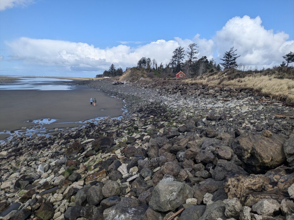 a rocky beach with a red house (MyCoast AI)