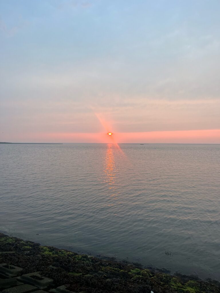 a sunset over a body of water (MyCoast AI)
