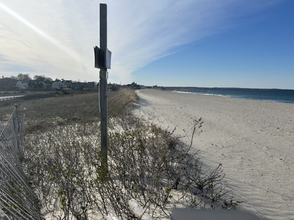 a beach with a fence and a sign (MyCoast AI)