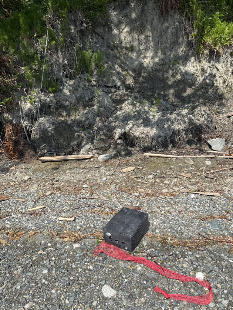a black rectangular object on a rocky surface (MyCoast AI)