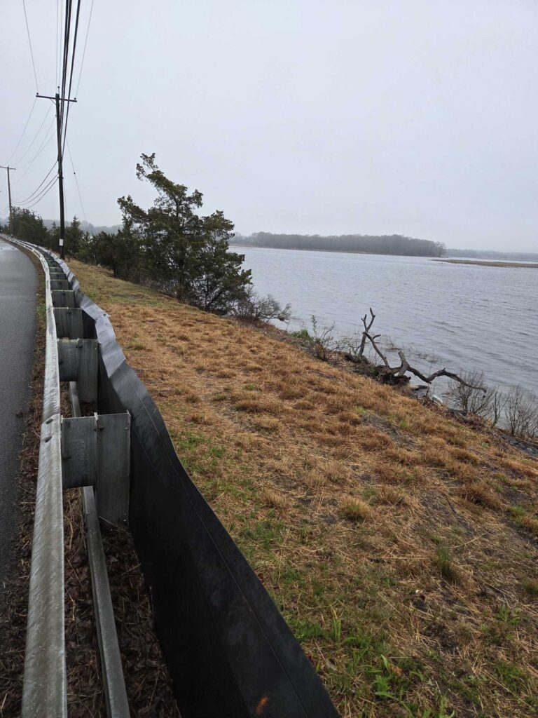 a wooden fence next to a body of water (MyCoast AI)