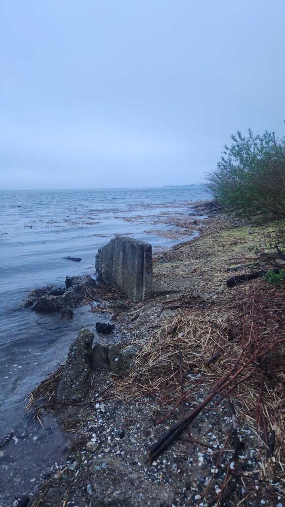 a rocky beach with a wooden structure (MyCoast AI)
