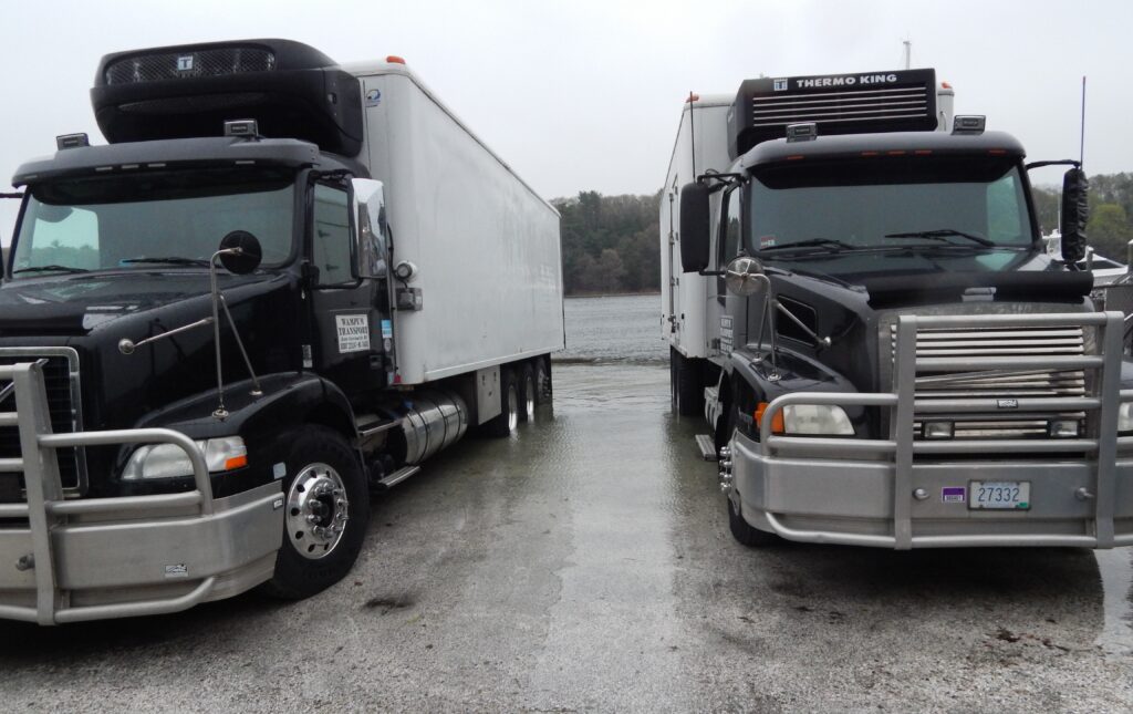 a couple of semi trucks parked next to each other (MyCoast AI)