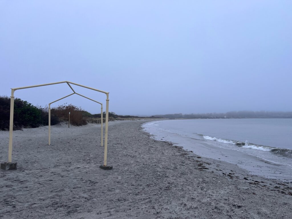 a beach with a net and a beach with a body of water (MyCoast AI)